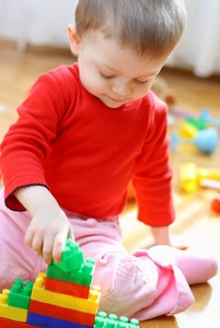 baby putting puzzle together